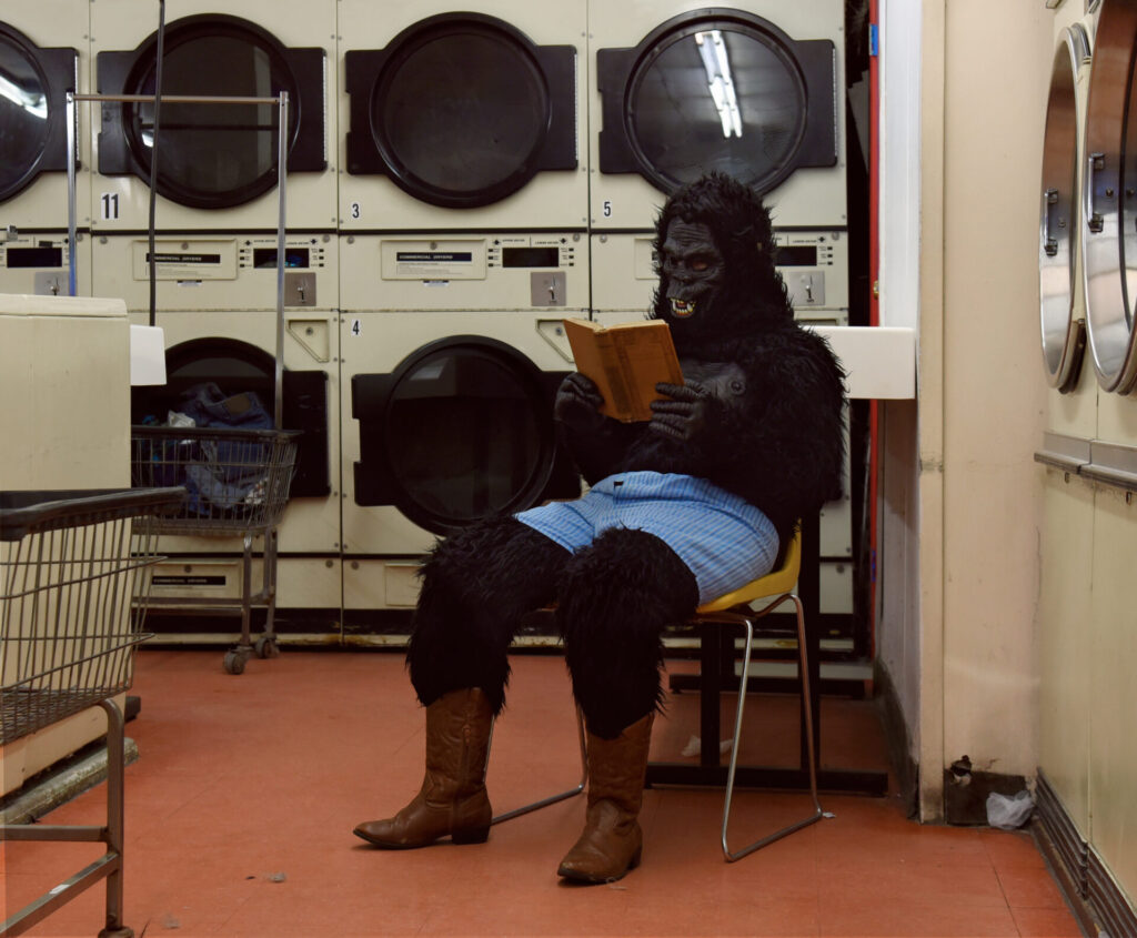 A,Person,In,A,Gorilla,Costume,Is,Sitting,In,A