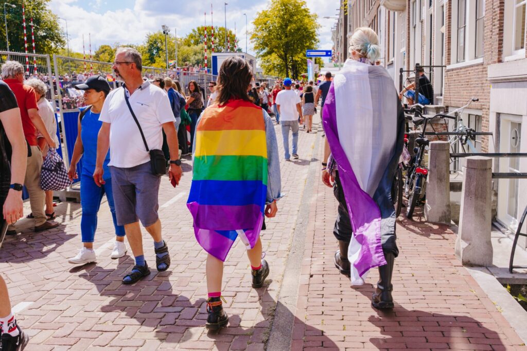 People,Wrapped,Up,In,Lgbt,Pride,Flag,And,In,Asexual