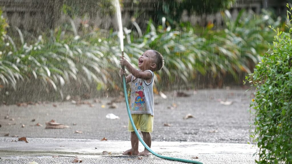 Happy,Little,Boy,Play,With,Water,Hose.,Smile,Asian,Child